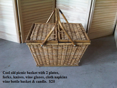 Cool old picnic basket with 2 plates,
   forks, knives, wine glases, cloth napkins
   wine bottle basket & candle.  $20